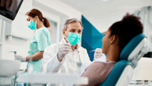 Dentist and hygienist with patient discussing Prevention for Life