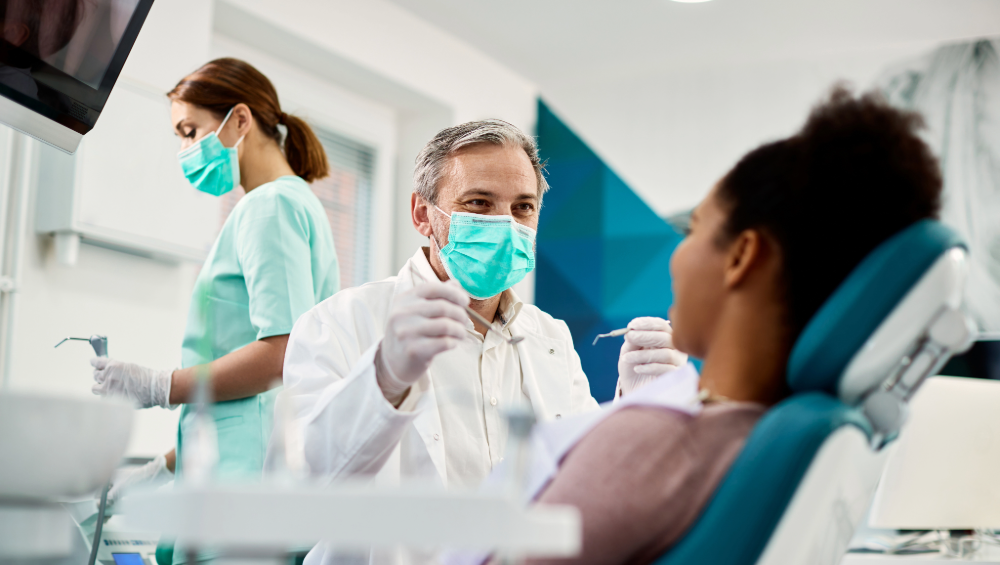 Dentist and hygienist with patient discussing Prevention for Life